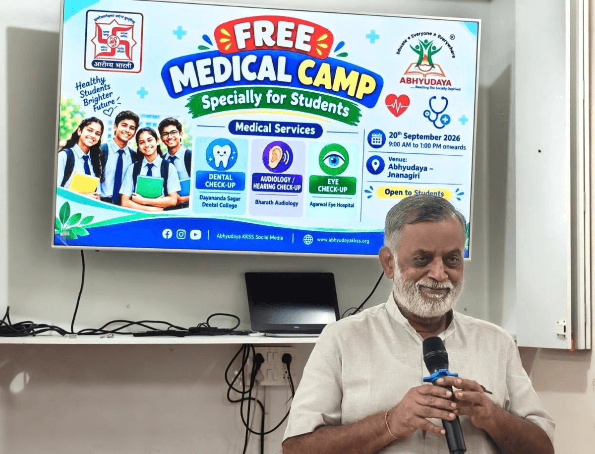 Speaker addressing students at the free medical camp at Jnanagiri