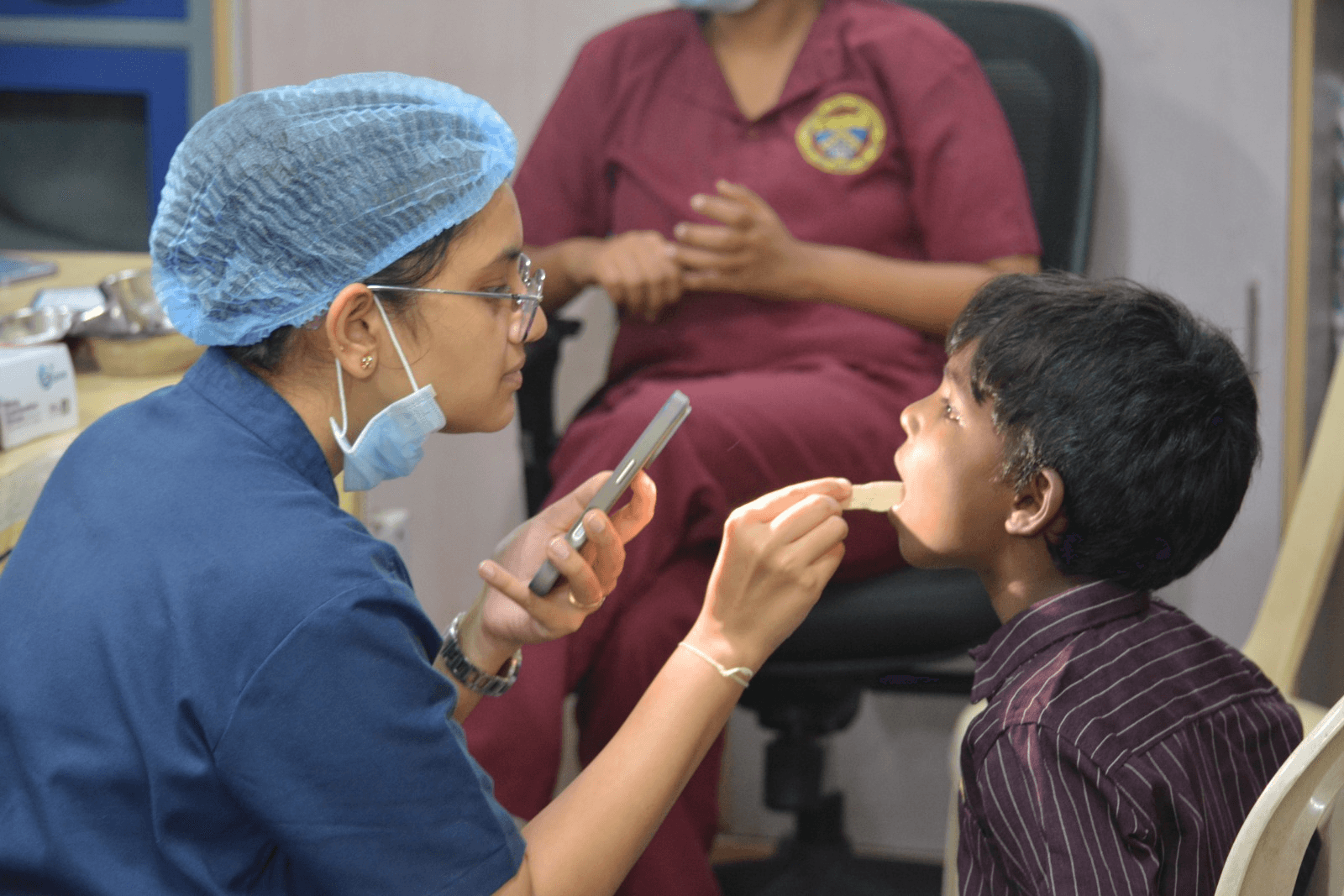 Healthcare professional examining a child during the medical camp